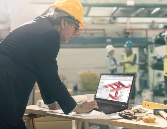 Lenovo ThinkPad P15 laptop open 90 degrees on a wooden table in a construction zone