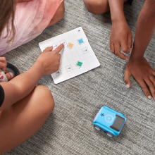 Kids solving puzzles with the challenge card for the indi learning robot toy.