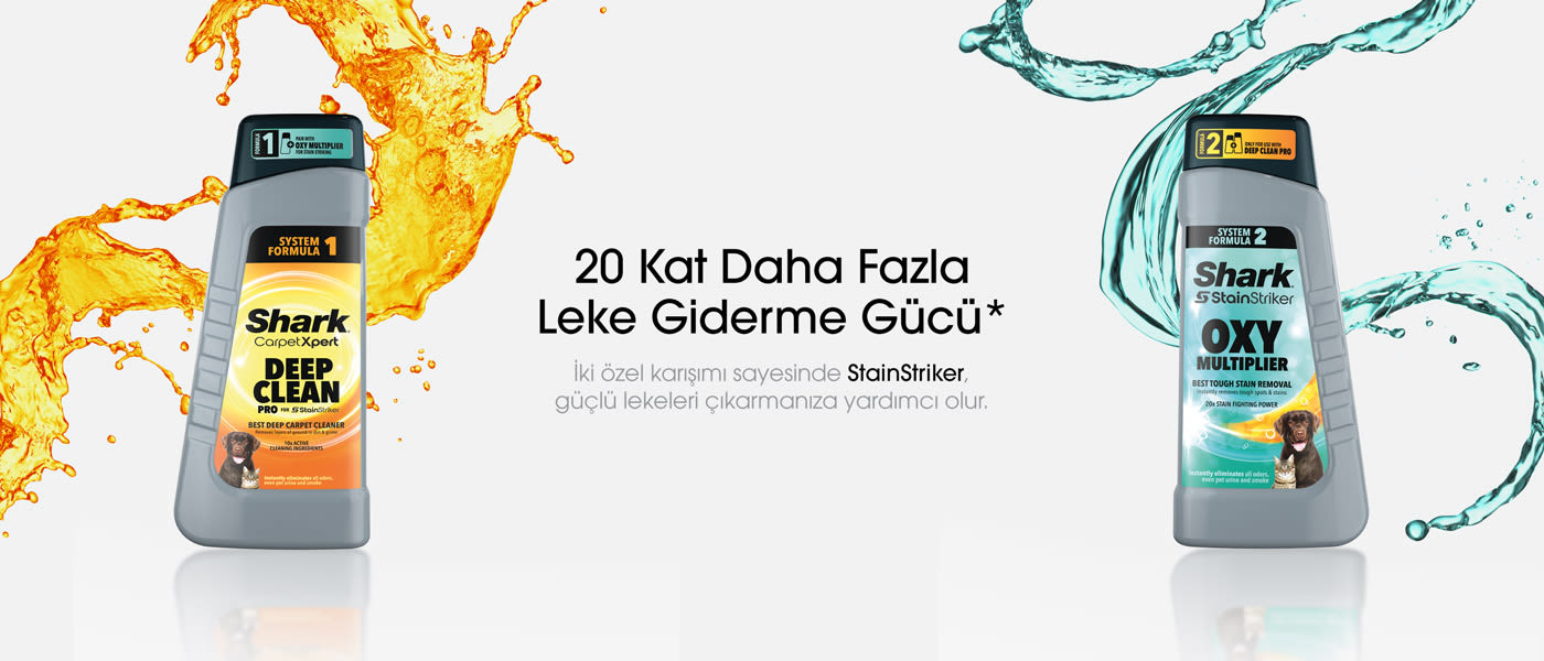 Beyaz zemin üzerinde, turuncu ve mavi sıvı sıçramalarıyla çevrili iki adet Shark leke çıkarıcı şişesi bulunur.
