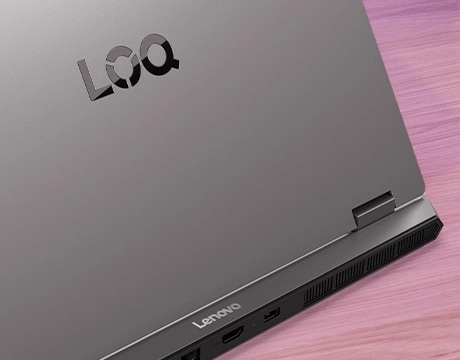 Masa üzerinde Lenovo LOQ Essential 15IRX11 dizüstü oyun bilgisayarı - arkadan görünüm, kapak kısmen açık, sol menteşeye odaklanmak için yakından kırpılmış.