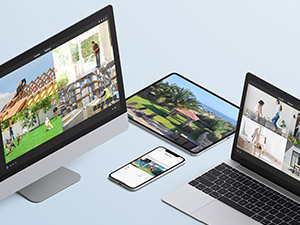 bir masa üzerinde bir dizüstü bilgisayar, bir telefon ve bir tablet.