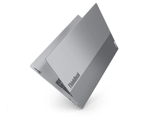Floating Lenovo ThinkBook 16 Gen 7 laptop with cover almost completely closed, standing on right, front corner to focus on ThinkBook ID on top cover.