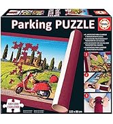 Metin "Parking Puzzle" yazılır. Karikatür tarzında araba, binalar ve trafik unsurları ile şehir sahnesini gösteren masa oyunu paketi.