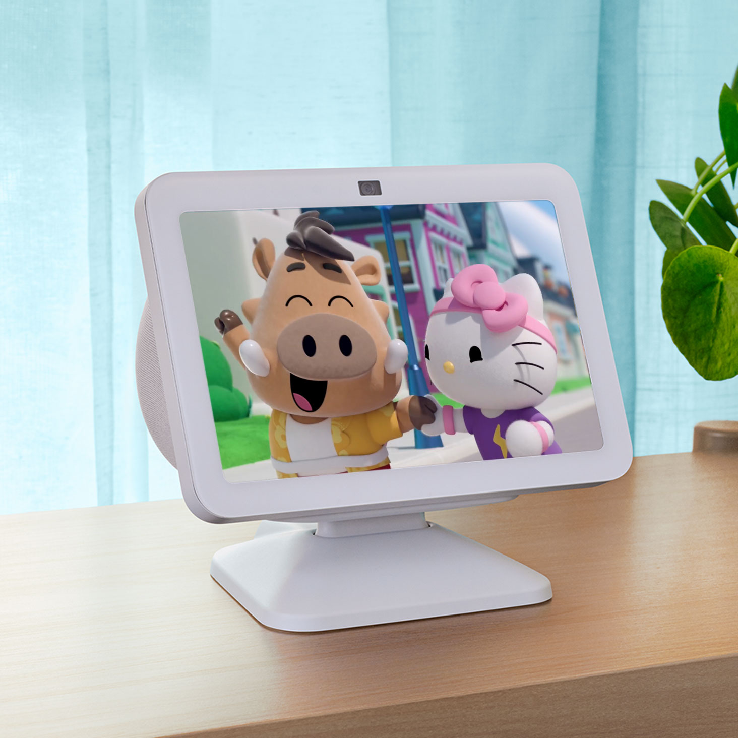 Echo Show 8, ekranda Hello Kitty ile birlikte ahşap bir masanın üzerinde oturuyor.