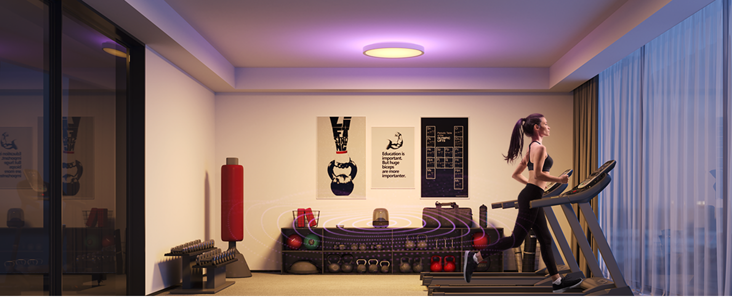 home gym setup with treadmill, red punching bag, and exercise equipment in a modern living room with artwork on white walls.