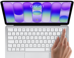 MacBook Neo, gümüş rengi, ekranda oturum açma penceresi gösteriliyor, kullanıcının parmağı klavyenin sağ üst köşesindeki Touch ID sensörüne dokunuyor